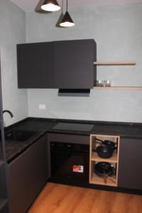 a kitchen with a black counter top and a stove at Bonbon in Treviso