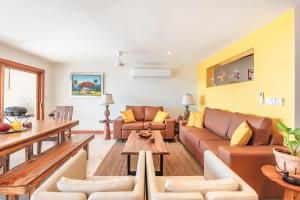 a living room with a couch and a table at 3BR Beachfront townhouse at Puerto Bahia in Santa Bárbara de Samaná