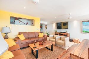 a living room with a couch and a table at 3BR Beachfront townhouse at Puerto Bahia in Santa Bárbara de Samaná