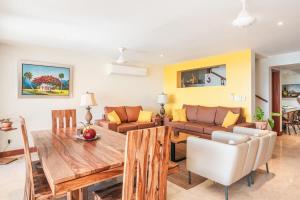 a living room with a table and a couch at 3BR Beachfront townhouse at Puerto Bahia in Santa Bárbara de Samaná +25 photos
