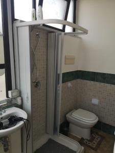 a bathroom with a shower and a toilet and a sink at Terrasini 218 in Terrasini