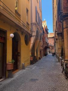 an alley with buildings and bicycles on a street at Guesthouse Locanda Regina Sofia in Bologna