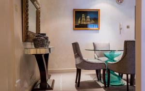 a dining room with chairs and a table and a mirror at 9 Hertford Street Mayfair in London