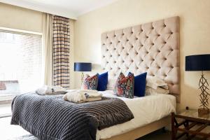 a bedroom with a large bed with a large headboard at 9 Hertford Street Mayfair in London