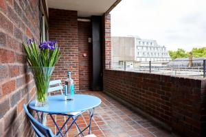 a table with a vase of flowers on a patio at 9 Hertford Street Mayfair in London