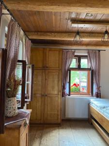 a bedroom with a bed and a window at Chalupa Na Bačáku in Frýdek-Místek