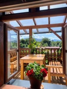 a balcony with a wooden table and a plant at Chalupa Na Bačáku in Frýdek-Místek