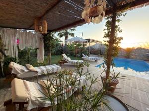 a backyard with a pool and a patio with furniture at Villa Zalin in Ovacik