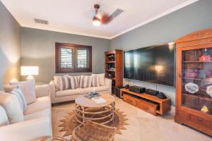 a living room with a large flat screen tv at Seaside Bliss with pool and spectacular view in Las Minas