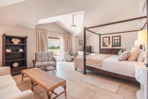 a bedroom with a large bed and a living room at Seaside Bliss with pool and spectacular view in Las Minas