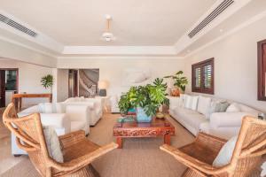 a living room with white furniture and a table at Seaside Bliss with pool and spectacular view in Las Minas +41 photos
