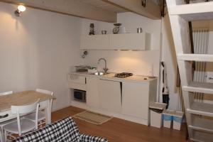 a small kitchen with a sink and a table at Appartamento della Baia in Sestri Levante
