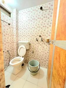 a bathroom with a toilet and a bucket at Zipcode Kashi in Varanasi