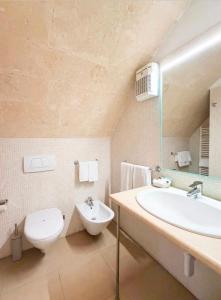 a bathroom with a white toilet and a sink at Residence Del Casalnuovo in Matera