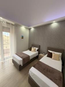 a hotel room with two beds and a window at Saraceno House G&P in Adrano +51 photos