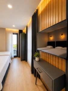a bedroom with two beds and a desk in it at Dream Hotel in Trabzon