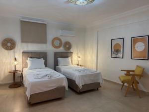 a bedroom with two beds and a table and a desk at Villa Zalin in Ovacik +58 photos