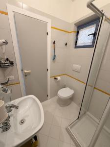 a bathroom with a toilet and a sink and a shower at Blu 31 Marcelli in Marcelli +11 photos