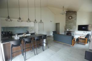 a kitchen with a counter and a bar with stools at Two Seas Residence - Boutique Residences in Ooty