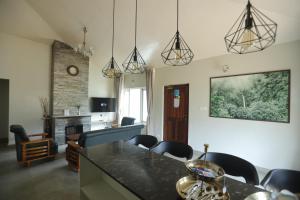 a kitchen and living room with a table and chairs at Two Seas Residence - Boutique Residences in Ooty