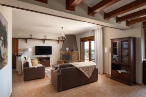 a living room with a couch and a tv at The Grand Panorama Villa in Nea Moudania