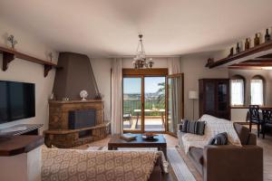 a living room with a couch and a fireplace at The Grand Panorama Villa in Nea Moudania +36 photos