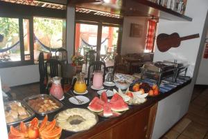 a buffet with many different types of food on a table at Pousada Legno Bossa Nova in Maceió +8 photos