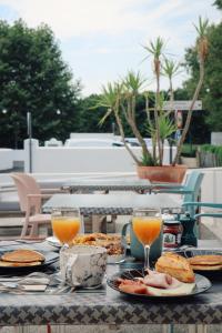a table with plates of food and glasses of orange juice at Lo Berge in Saint-Pée-sur-Nivelle