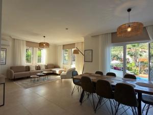 a large living room with a table and chairs at Villa Zalin in Ovacik
