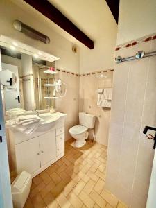 a bathroom with a toilet and a sink and a shower at Stella-Bianca in Sagone +13 photos