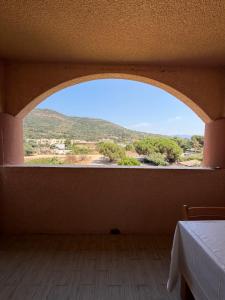 a room with a large window with a mountain view at Stella-Bianca in Sagone