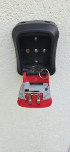 a red and black object is hanging from a ceiling at Apartman Heli Meli 1 in Jajce