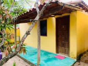 a house with a pool in front of it at Pousada Fanticelli in Nova Viçosa