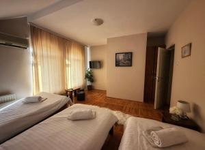 a hotel room with two beds and a window at Balkan 024 in Subotica +42 photos