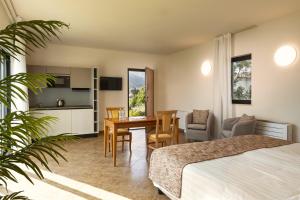a hotel room with a bed and a table and chairs at Suites Del Borgo in Olbia
