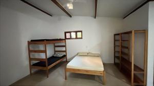 a room with two bunk beds and a table at Pousada Fanticelli in Nova Viçosa +13 photos