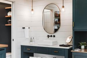 a bathroom with a sink and a mirror at Glamping cabin with private deck and hot tub! in Guntersville
