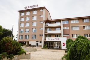 a building with a sign on top of it at Houseboat Glamour & wellness in Kaluža