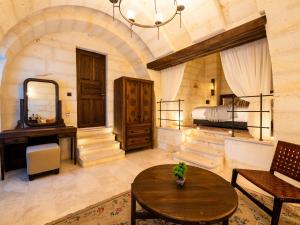 a bedroom with a bed and a table in a room at Cybele in Cappadocia in Uçhisar