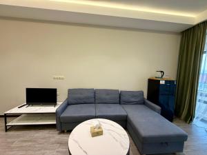 a living room with a blue couch and a table at Sevanavanq Inn Hotel in Sevan