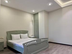 a bedroom with a large bed with white walls at Sevanavanq Inn Hotel in Sevan +13 photos