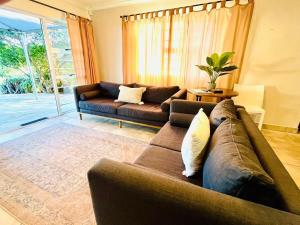 a living room with a brown couch and a table at Lieben Gast in De Kelders +8 photos