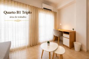 a living room with a desk and a table at Rooms4you 2 in historic center of Braga in Braga