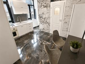 a kitchen with a table and chairs and a counter at AFY STAYS Boutique Apartments in Bucharest +233 photos