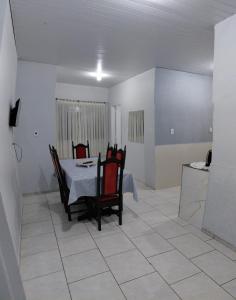 a dining room with a table and chairs at Pousada familiar 07 in Rio do Sul