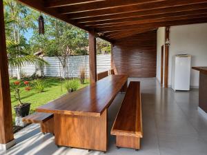 a wooden table and benches on a patio at Rancho Nova Car in Ariquemes