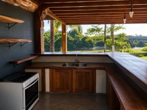 a kitchen with a sink and a window at Rancho Nova Car in Ariquemes