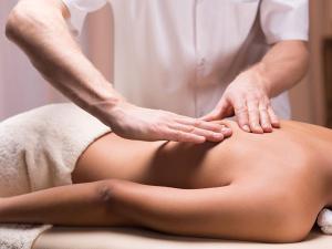 a woman getting a back massage from a therapist at CA Assiolo in Senigallia