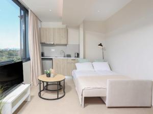a living room with a bed and a coffee table at Suel Suites Afitos in Afitos