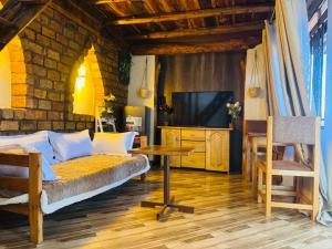 a bedroom with a bed and a table and a tv at Eagle Nest in Namulanda